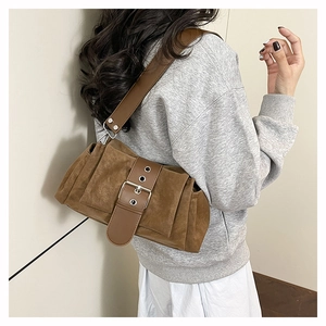 Vue détaillée du sac bandoulière en daim marron avec plis et large bandoulière