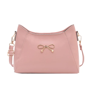 Minimalist pink leather crescent shoulder bag featuring a gold bow buckle and strap