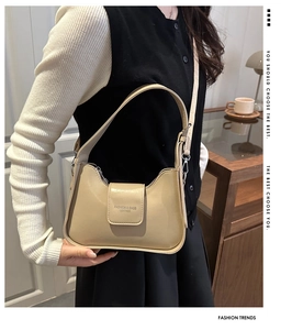 Detail of beige faux leather shoulder bag featuring magnetic flap and adjustable strap