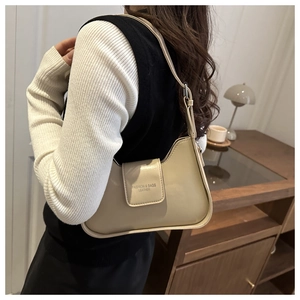 Close-up of cream leather underarm bag featuring Fashion & Bags embossed lettering