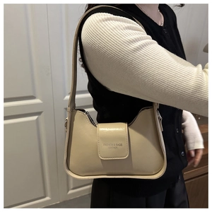 Macro view of beige minimalist leather handbag with Fashion & Bags lettering detail