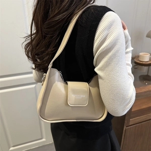 Minimalist beige leather shoulder bag with arc zipper and embossed fashion text