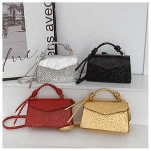Mini handbags in silver black red and gold with knotted handles and metallic textures