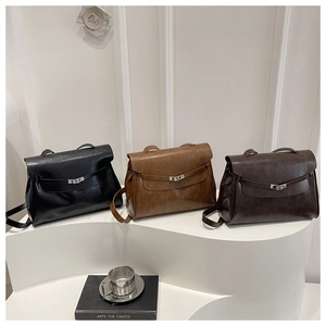 Detailed view of structured leather crossbody bags with metal twist-lock in three colors