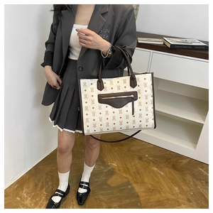 Detail of cute bear print tote bag showing the front zipper pocket and strap attachment