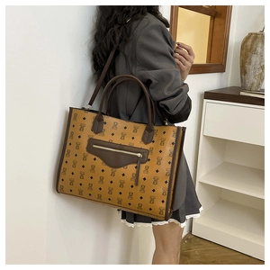 Detail of bear pattern and diamond texture on high-capacity brown faux leather tote bag