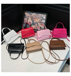 Top view of mini crossbody bags in seven vibrant colors with wavy flap edge design