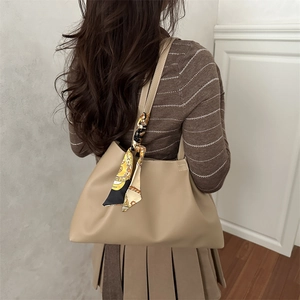Beige oversized pleated tote bag with decorative silk scarf on shoulder strap