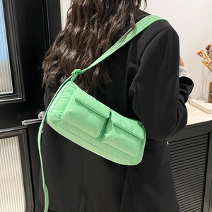 Mint green nylon padded shoulder bag with dual front pockets and tied strap detail