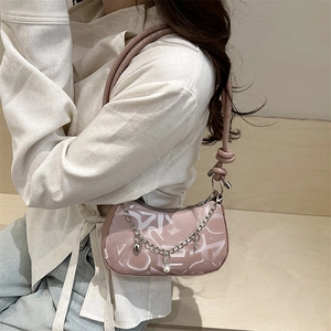 Pink faux leather baguette bag with chain detail and all-over letter print pattern