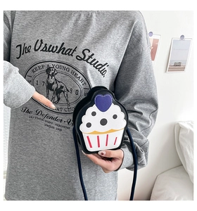 Detailed view of creative cupcake shaped crossbody bag with colorful icing pattern