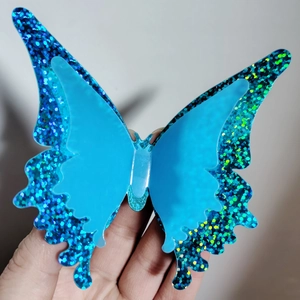 Detail view of 3D double-layered blue butterfly wall sticker with glitter texture