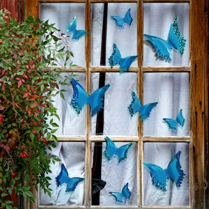 Blue 3D luminous butterfly wall stickers with glitter on a vintage window frame