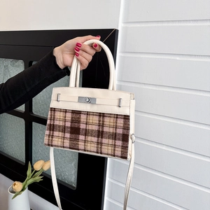 Elegant vintage-style plaid handbag with cream leather accents and top handle