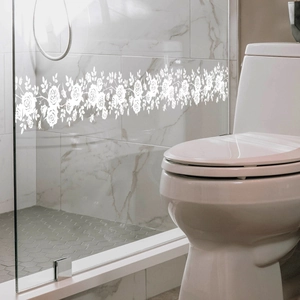White rose floral pattern static window film applied to a bathroom glass door surface