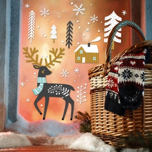 Detail of Christmas window stickers with elk and snowflakes in a cozy winter setting