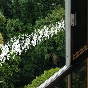 Close-up of white rose vine static window stickers showing intricate floral details