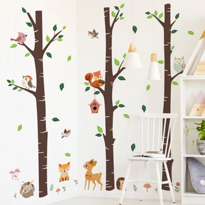 Detail of forest animal wall stickers with birch trees, foxes and deer in a nursery room