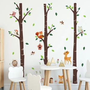Forest animals and tree wall stickers in a kids room with deer, owls and squirrels