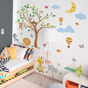 Detailed wall sticker layout featuring cartoon animals and tree in a cozy nursery room