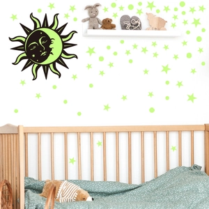Luminous wall stickers with sun, moon and stars in a cozy baby room decor scene