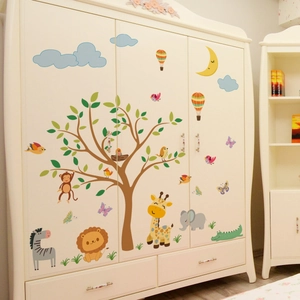 Detail of forest animals and tree wall stickers applied on a white wooden closet