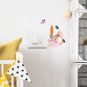 Detail of bunny and butterfly wall stickers applied next to a light switch in a room