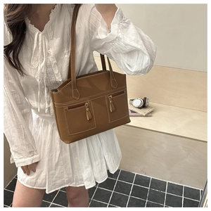 Detail view of large brown vintage tote bag with contrast stitching and double zip pockets