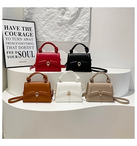 Detailed view of structured square handbags in five colors with knotted handle decoration