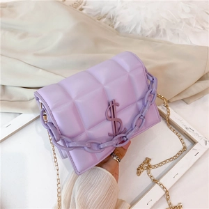 Close-up of light purple quilted mini bag with gold chain strap and dollar sign logo