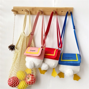 Detail of cute duck-themed canvas crossbody bags featuring 3D feet and fluffy tail design