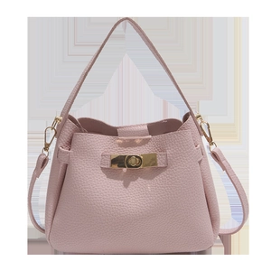 Minimalist soft pink litchi grain leather bucket bag with elegant gold twist lock