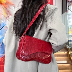 Red crocodile texture saddle shoulder bag with gold hardware and stylish flip magnetic closure