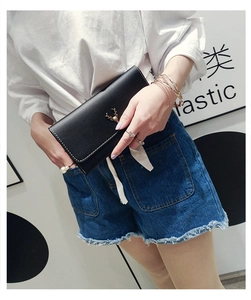 Close-up of black PU leather long wallet with white stitching and golden deer metal detail