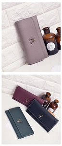 Detail showing vintage deer head metal ornament and fine stitching on faux leather wallets