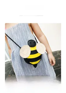 Kids cute bee crossbody bag featuring yellow stripes and white wings detail on a model