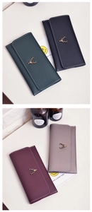 Detail of four long wallets in dark green, black, burgundy and grey with deer metal logo