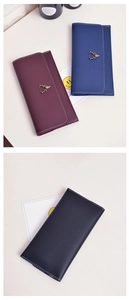 Detail of slim long wallets featuring vintage metal deer logo and white contrast stitching