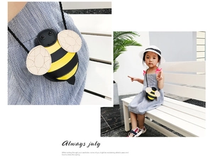 Close-up of cute cartoon bee crossbody bag featuring yellow stripes and stitched wings