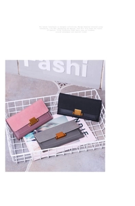 Three long frosted wallets in pink, black, and grey with metal buckles in a white basket