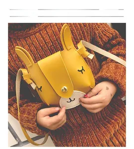 Close-up of cute yellow bunny crossbody bag with 3D ears on a child model