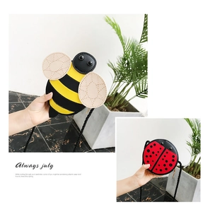 Detail of cute bee and ladybug kids crossbody bags with woven shoulder straps