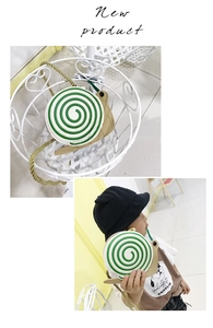 Detail of snail-shaped kids crossbody bag with spiral pattern and woven gold strap