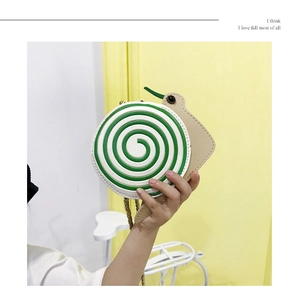 Detail of cute green spiral snail-shaped crossbody bag for kids with candy theme