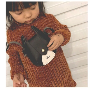Detail of cute deer-themed kids mini shoulder bag with animal ears and gold snap button