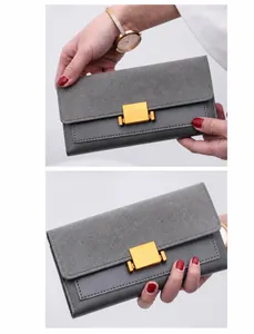 Detail of gray bi-material wallet with matte finish and elegant gold square buckle clasp