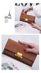 Detail of a brown bicolor women's long wallet featuring a gold square buckle and dual texture