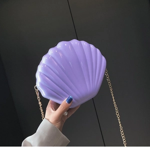 Glossy purple shell-shaped evening clutch bag with pearl clasp and gold chain strap