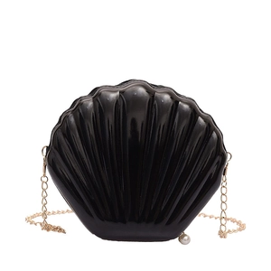 Glossy black shell-shaped evening clutch bag with gold chain and pearl pendant accessory