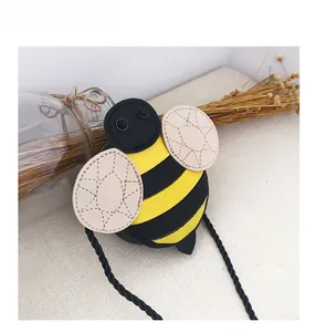 Detail showing the honeybee pattern crossbody bag with yellow and black stripes